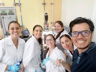 Foto del Dr. Sánchez posando en el laboratorio junto a 5 investigadoras.